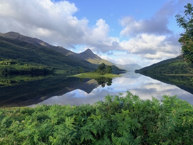 Highland landscape with mountain lake reflection